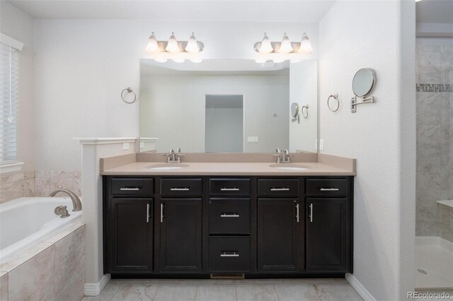 8230 Misty Moon Dr, Colorado Springs, CO 80924 - bathroom with double vanity, a garden tub, and a tile shower