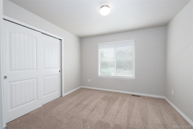 8230 Misty Moon Dr, Colorado Springs, CO 80924 - unfurnished bedroom featuring light colored carpet, baseboards, and a closet