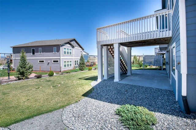 8230 Misty Moon Dr, Colorado Springs, CO 80924 - view of grassy yard featuring stairs, a patio, and a wooden deck