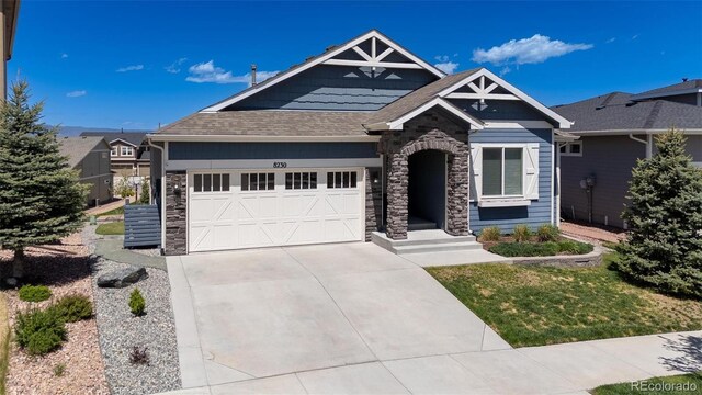 8230 Misty Moon Dr, Colorado Springs, CO 80924 - craftsman-style house featuring stone siding, driveway, a garage, and roof with shingles