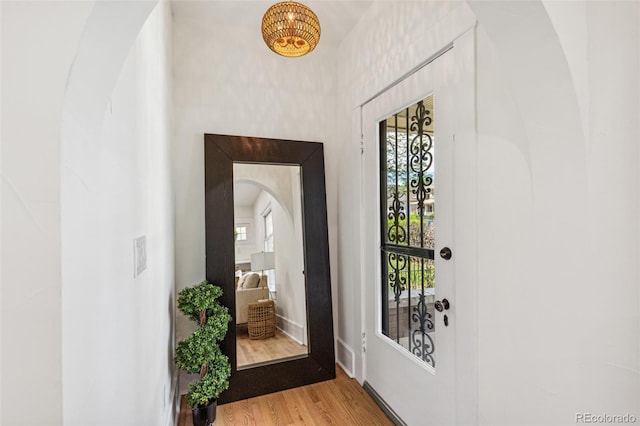 2738 W 38th Ave, Denver, CO 80211 - foyer featuring arched walkways, light wood-type flooring, and baseboards