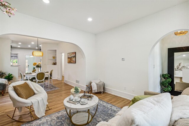 2738 W 38th Ave, Denver, CO 80211 - living area featuring arched walkways, wood finished floors, and recessed lighting