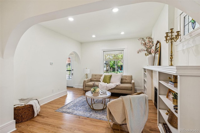 2738 W 38th Ave, Denver, CO 80211 - living area featuring arched walkways, baseboards, light wood finished floors, and recessed lighting