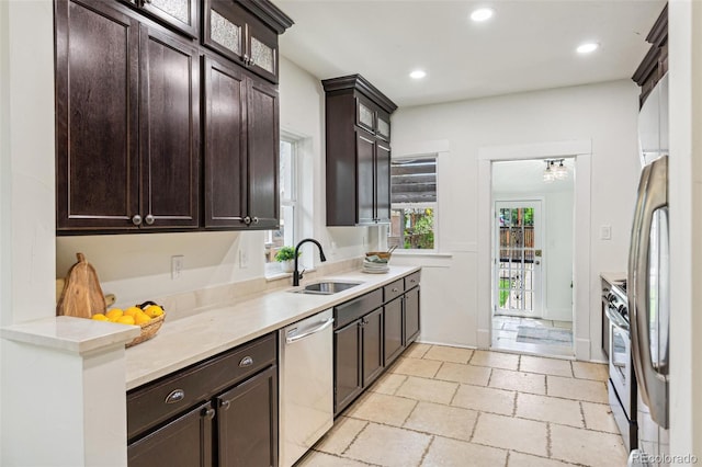 2738 W 38th Ave, Denver, CO 80211 - kitchen with appliances with stainless steel finishes, a sink, dark brown cabinets, light countertops, and glass insert cabinets
