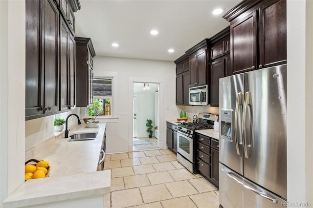 2738 W 38th Ave, Denver, CO 80211 - kitchen with appliances with stainless steel finishes, a sink, dark brown cabinetry, recessed lighting, and light countertops