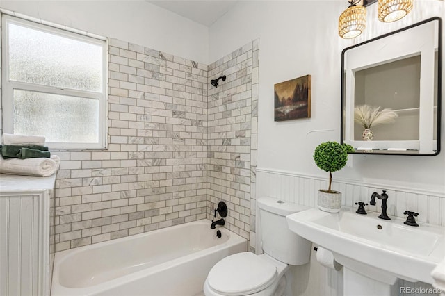 2738 W 38th Ave, Denver, CO 80211 - full bath with a wainscoted wall, toilet, shower / tub combination, and a sink