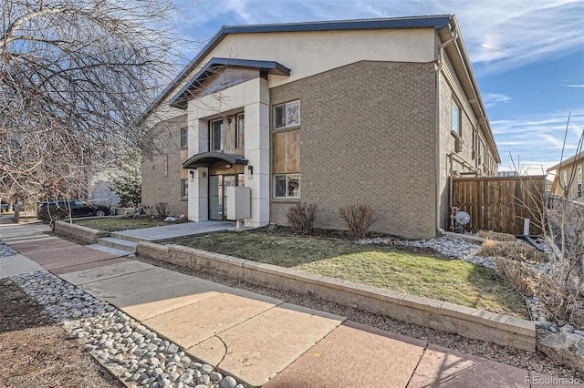 view of front of house with brick siding and stucco siding