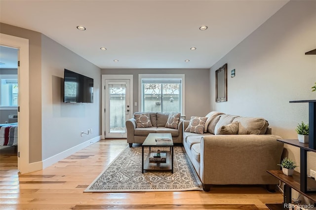 living room with recessed lighting, light wood-style flooring, and baseboards