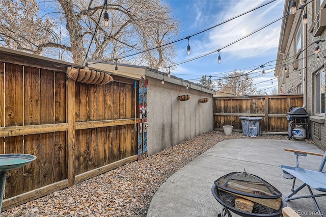 2460 W Caithness Pl Unit 104, Denver, CO 80211 - view of patio / terrace with a fire pit and area for grilling