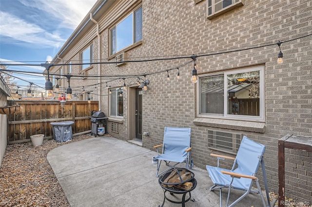 view of patio featuring grilling area and fence