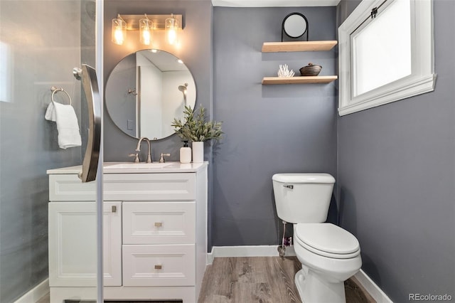 bathroom with vanity, hardwood / wood-style floors, and toilet