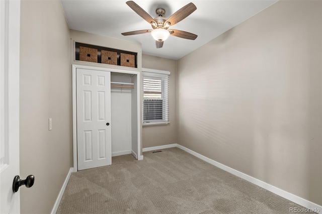 unfurnished bedroom with light carpet, a closet, and ceiling fan