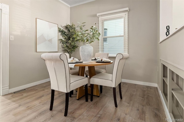 3024 S Sherman St, Englewood, CO 80113 - dining room with wood finished floors, baseboards, and ornamental molding