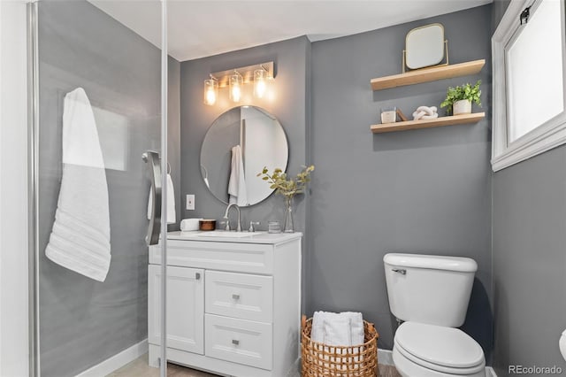 3024 S Sherman St, Englewood, CO 80113 - bathroom with toilet, vanity, and baseboards