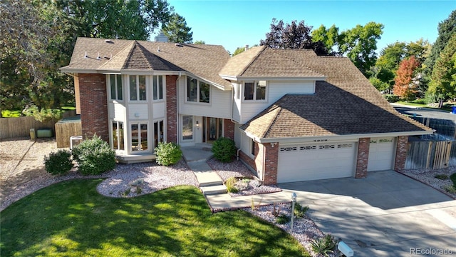 front of property featuring a front yard and a garage