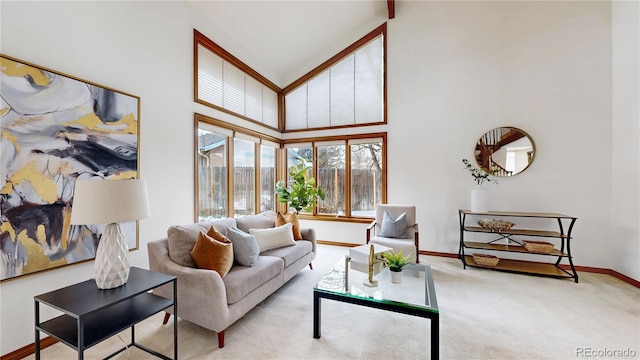 living room with a high ceiling and light carpet