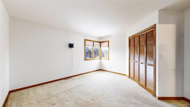 unfurnished bedroom with carpet flooring and a closet