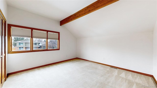 additional living space featuring light carpet and vaulted ceiling with beams