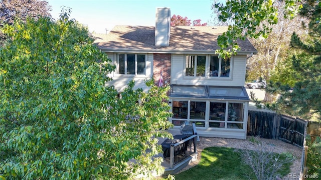 rear view of house with a sunroom