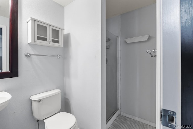 full bathroom with toilet and a stall shower