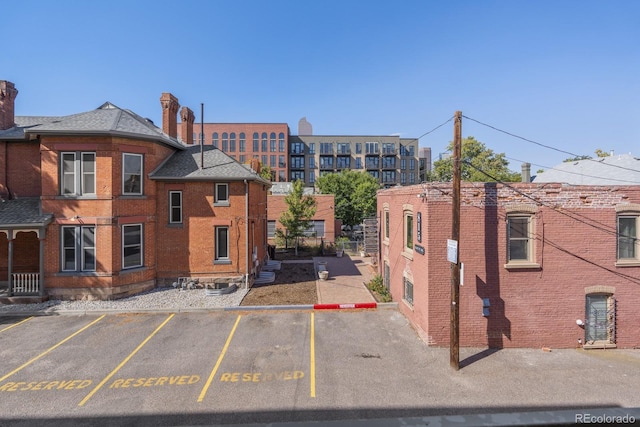 view of building exterior with uncovered parking