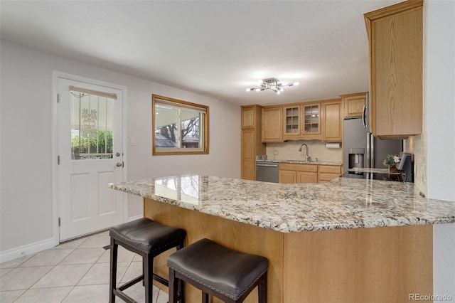 6280 Quay St, Arvada, CO 80003 - kitchen with appliances with stainless steel finishes, a sink, a peninsula, glass insert cabinets, and baseboards