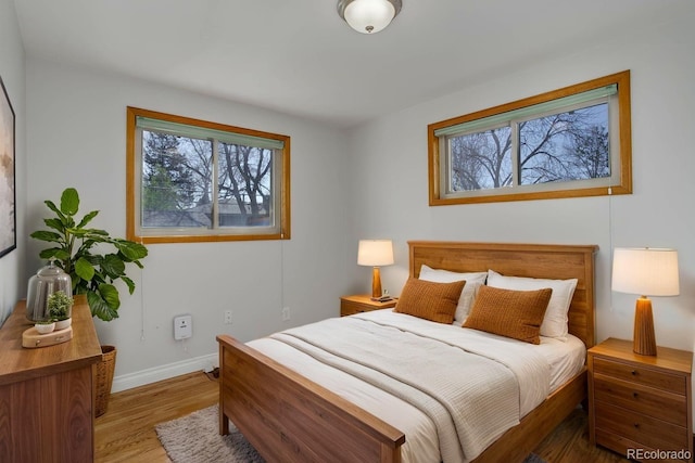6280 Quay St, Arvada, CO 80003 - bedroom with multiple windows, wood finished floors, and baseboards