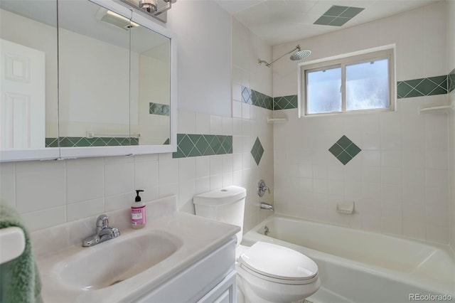 6280 Quay St, Arvada, CO 80003 - full bathroom with bathing tub / shower combination, tile walls, toilet, vanity, and backsplash