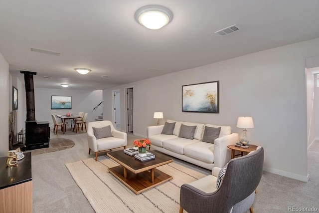6280 Quay St, Arvada, CO 80003 - living area featuring light carpet, a wood stove, and baseboards