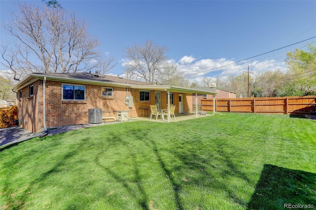 6280 Quay St, Arvada, CO 80003 - back of property with brick siding, central AC, and a patio area