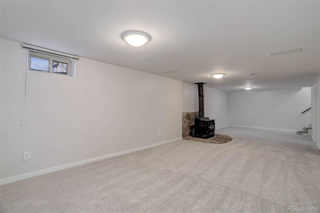 6280 Quay St, Arvada, CO 80003 - finished below grade area with a wood stove, carpet flooring, and baseboards