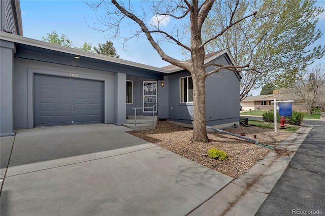 1972 S Carr St, Lakewood, CO 80227 - single story home featuring a garage, stucco siding, and driveway