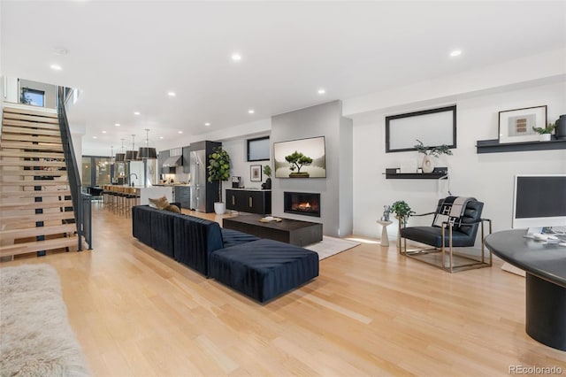 3709 Tejon St, Denver, CO 80211 - living room featuring a glass covered fireplace, stairway, light wood-style flooring, and recessed lighting
