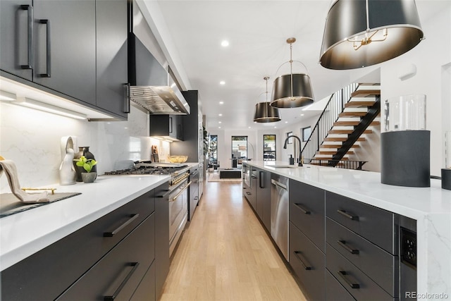 3709 Tejon St, Denver, CO 80211 - kitchen featuring modern cabinets, wall chimney range hood, recessed lighting, light countertops, and light wood-style flooring
