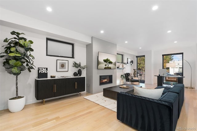 3709 Tejon St, Denver, CO 80211 - living area featuring light wood-style flooring, recessed lighting, and a glass covered fireplace