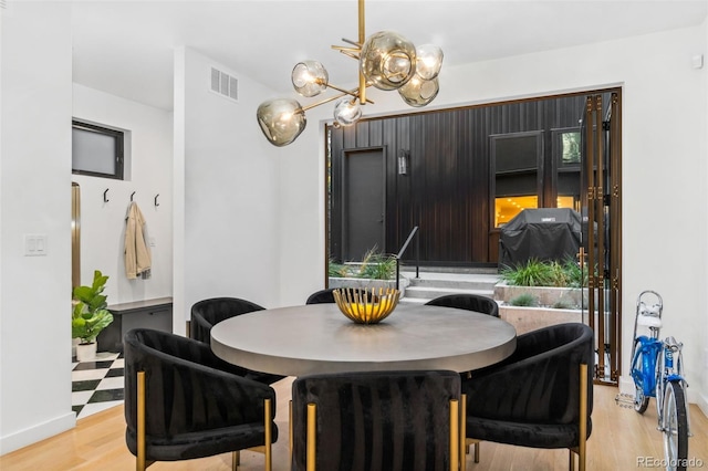 3709 Tejon St, Denver, CO 80211 - dining area featuring light wood-style flooring and a chandelier