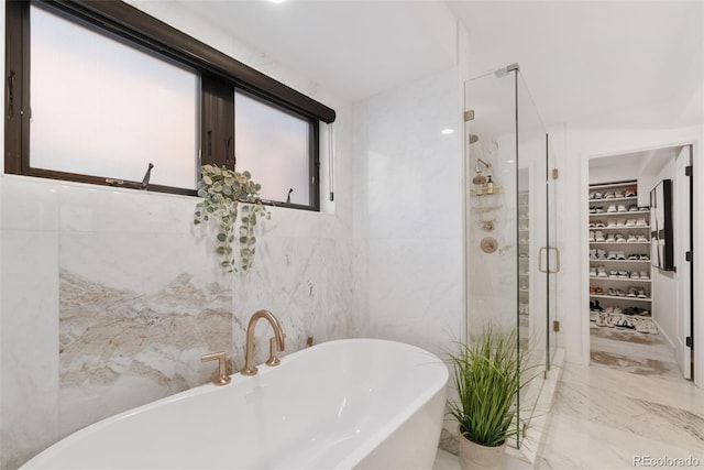 3709 Tejon St, Denver, CO 80211 - bathroom featuring a spacious closet, a shower stall, a freestanding bath, tile walls, and marble tiled flooring