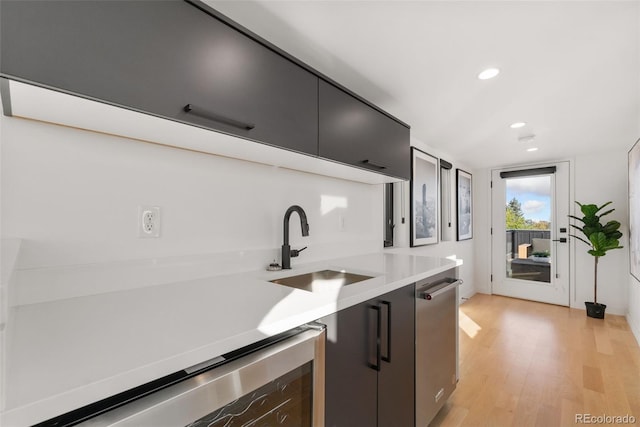 3709 Tejon St, Denver, CO 80211 - kitchen with light wood finished floors, light countertops, dishwashing machine, recessed lighting, and dark cabinetry