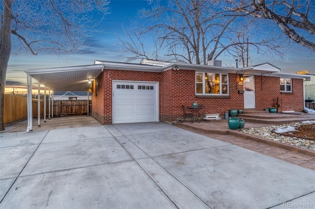 ranch-style house featuring a carport and a garage