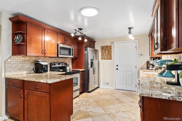 kitchen featuring tasteful backsplash, appliances with stainless steel finishes, light stone countertops, and pendant lighting