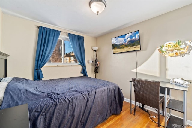 bedroom with hardwood / wood-style flooring