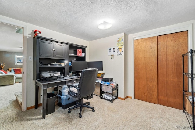 office space featuring carpet flooring and a textured ceiling