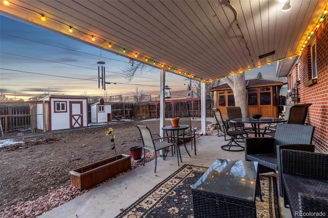 patio terrace at dusk with a storage shed