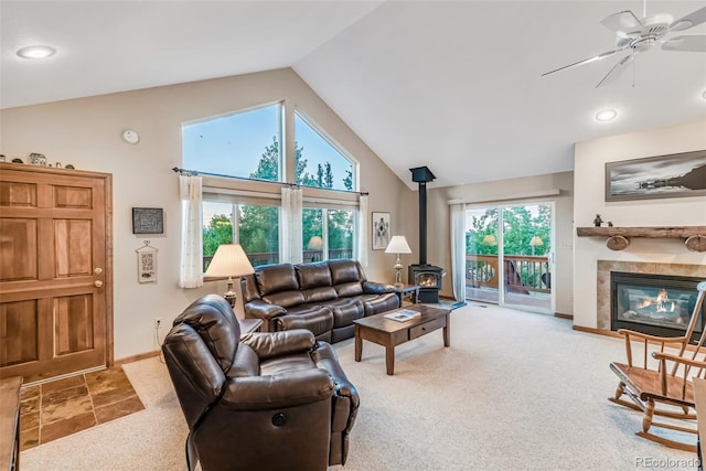 168 Mountain Vis, Como, CO 80432 - living area with a wood stove, a ceiling fan, carpet flooring, high vaulted ceiling, and a fireplace