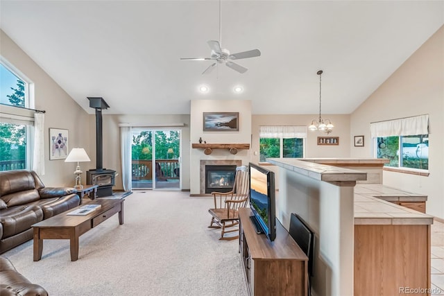 168 Mountain Vis, Como, CO 80432 - living room featuring a wood stove, a ceiling fan, light colored carpet, and high vaulted ceiling