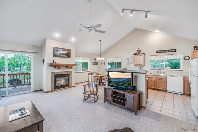 168 Mountain Vis, Como, CO 80432 - living room with lofted ceiling, ceiling fan, a tiled fireplace, plenty of natural light, and rail lighting