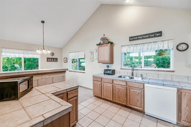 168 Mountain Vis, Como, CO 80432 - kitchen with white dishwasher, black microwave, tile counters, healthy amount of natural light, and high vaulted ceiling
