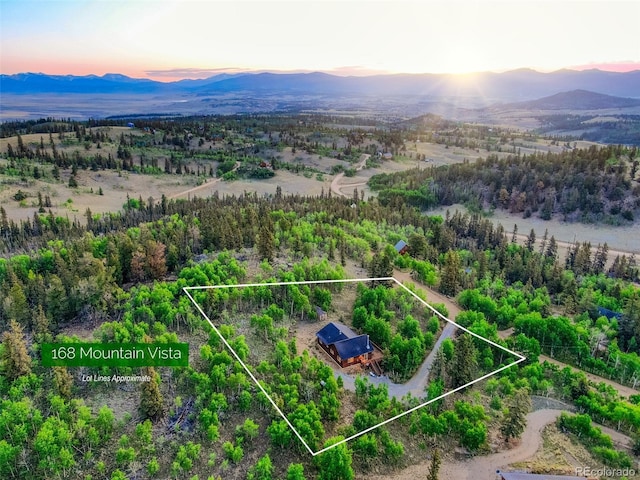 168 Mountain Vis, Como, CO 80432 - aerial overview of property's location with a mountain backdrop and property boundaries highlighted