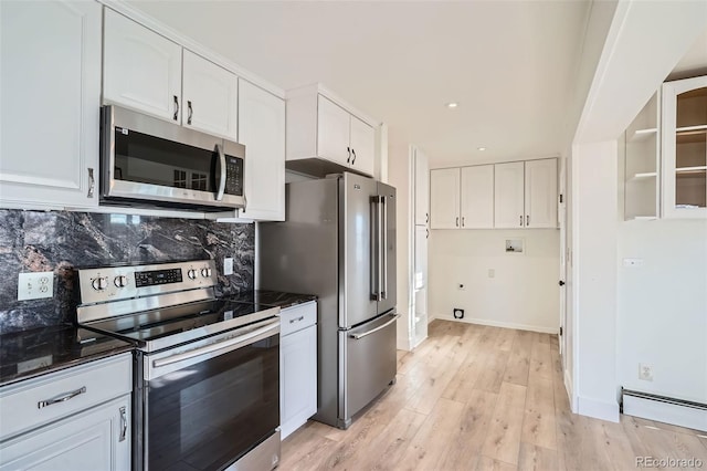 kitchen featuring a baseboard radiator, light hardwood / wood-style flooring, backsplash, white cabinets, and appliances with stainless steel finishes