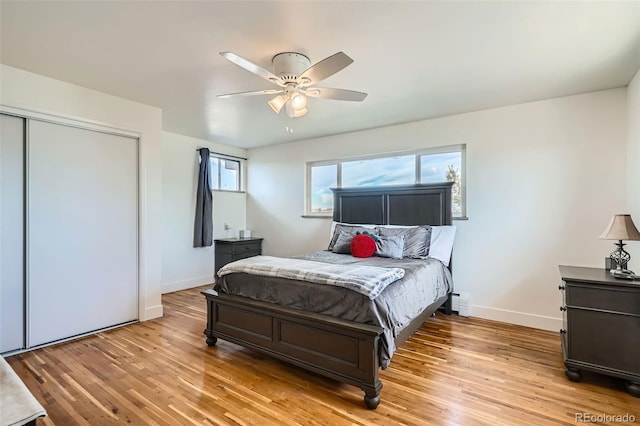 bedroom with light wood-type flooring, a closet, and ceiling fan